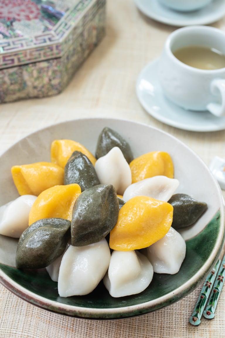 Korean half-moon shape rice cakes in yellow, green and white colors