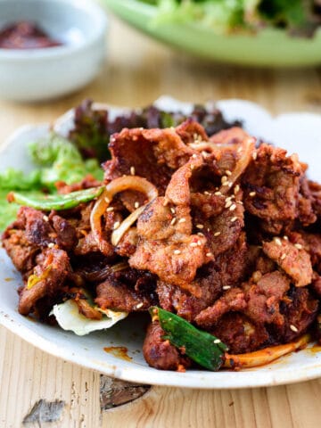 Spicy pork bulgogi served with lettuce wraps and ssamjang