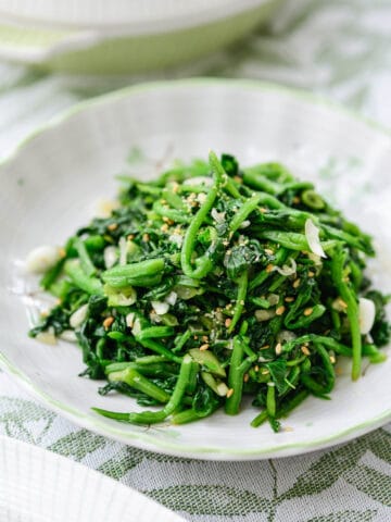 Blanched and seasoned watercress side dish served in a small plate