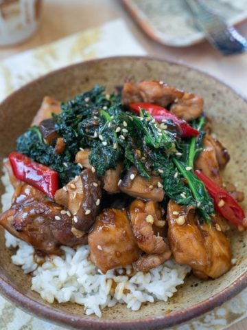 Chicken stir fry with vegetables served in a brown bowl