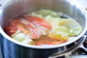 boiling vegetables in a pot for soft tofu and egg soup