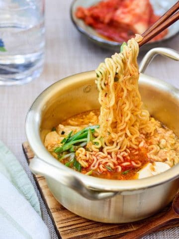 Korean ramen made with soft tofu served with kimchi