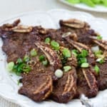 Korean beef short ribs in a plate with lettuce in the background