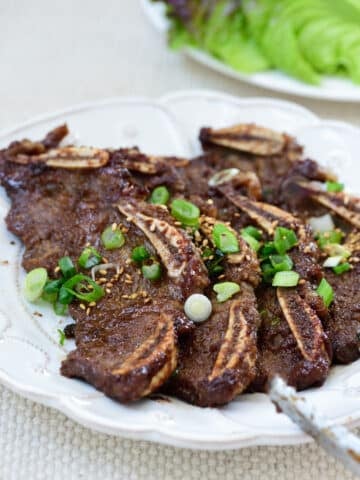 Korean beef short ribs in a plate with lettuce in the background